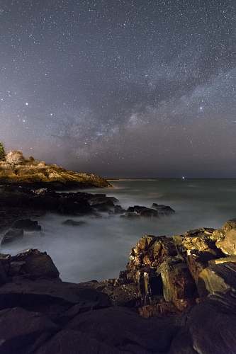 milky way mountains under starry sky night